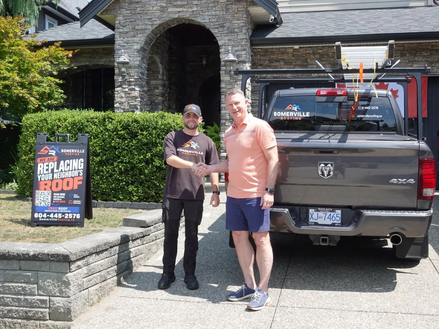 A Somerville Roofing customer beside the company truck after a completed roof