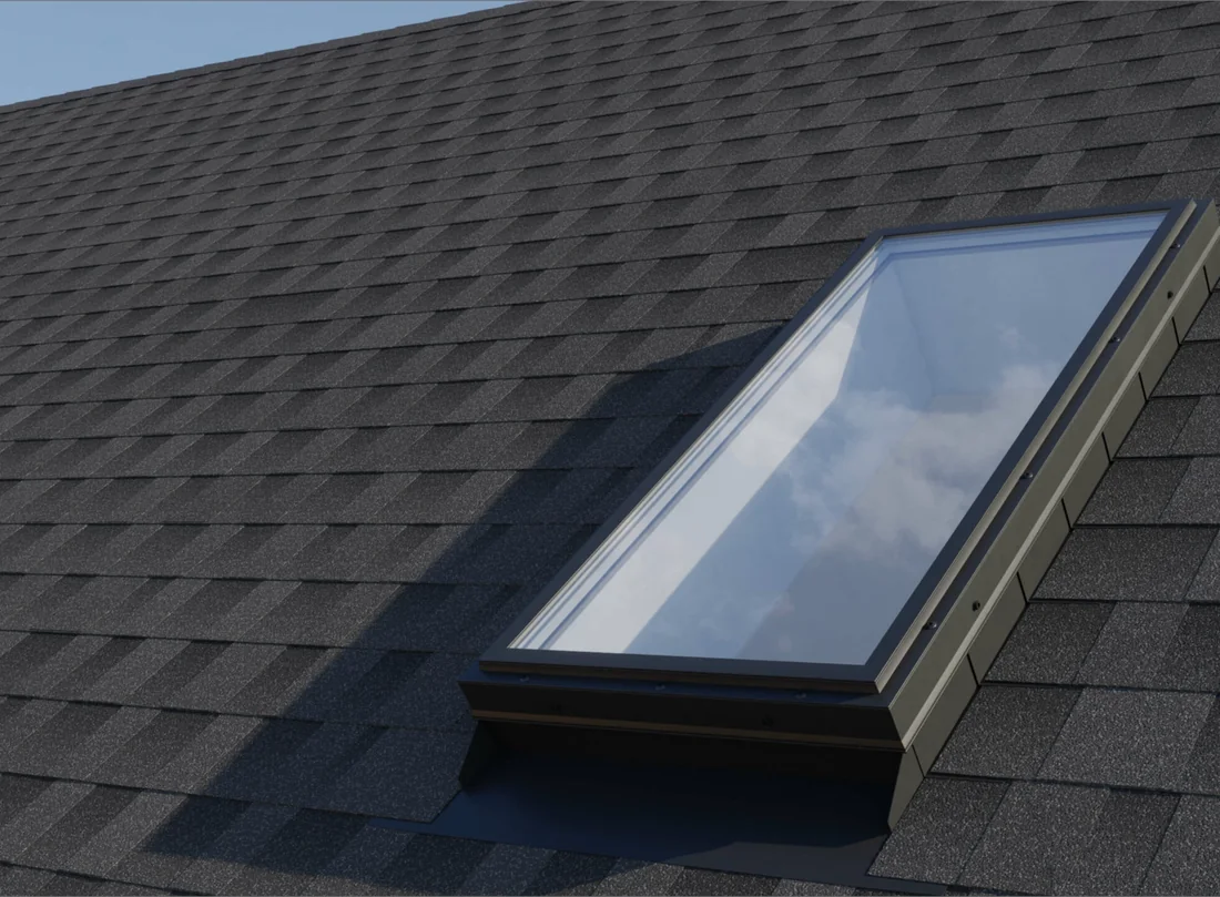 A Columbia self-flashing fixed acrylic dome skylight seated in an architectural shingle roof